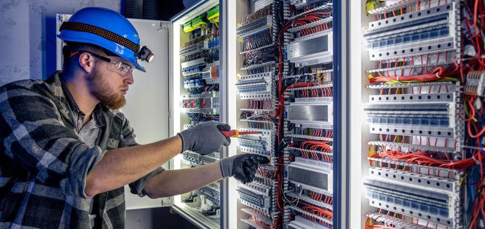 Thakur Shroff — electrician working on an industrial electrical distribution panel